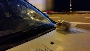 Stone penetration hole on a car's front window. the stone is in a bag on the car. Photos credit: Tazpit News Agency.
