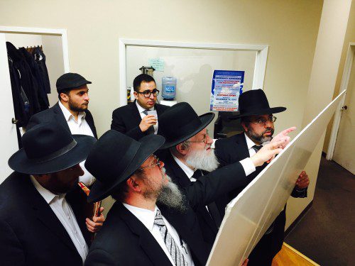 L-R Rabbis Eidlitz, Heinemann and Lalezarian examining the map
