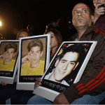 Terror victim families with photos of their loved ones at a demonstration against releasing prisoners in 2013. Photo by Hillel Maeir/TPS on December 20, 2015